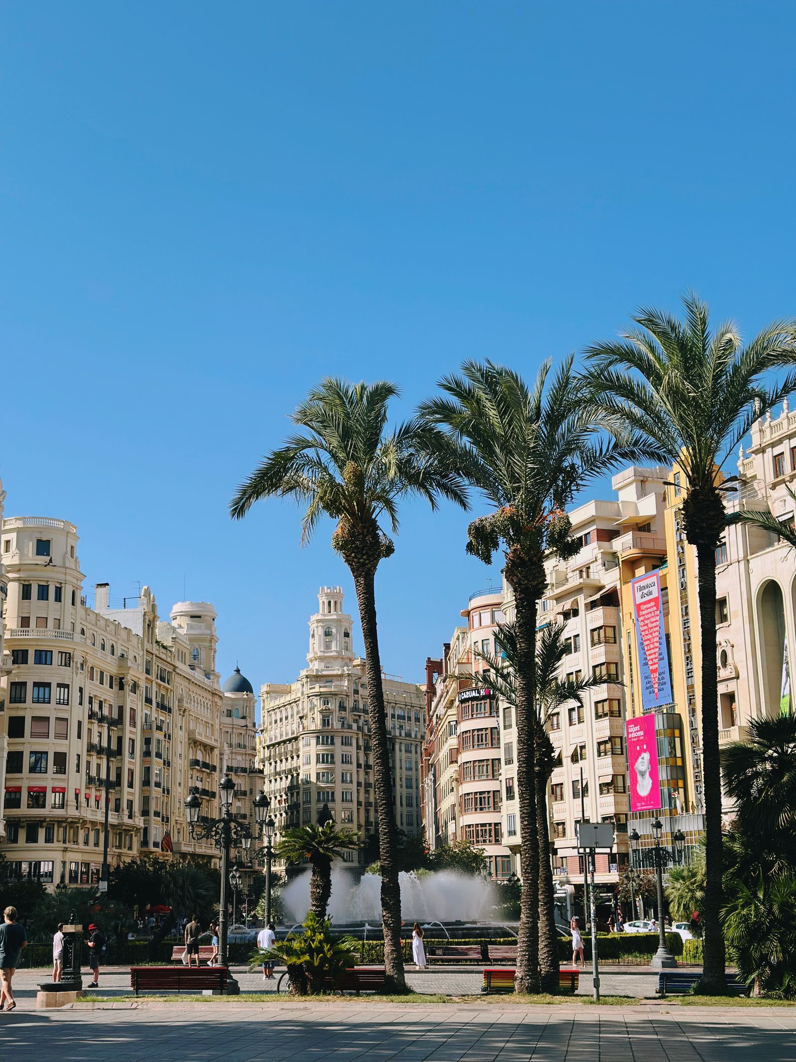 A view of Valencia with palm trees and a fountain